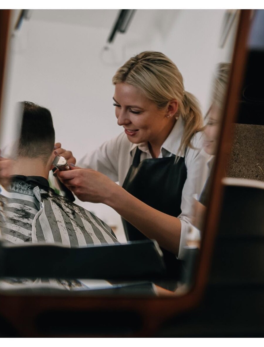 Finishing touches on a fresh haircut, reflected in the mirror